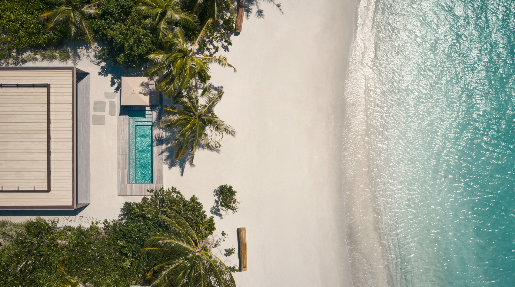 An aerial view of the beach pool villas at Patina Maldives