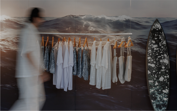 Coastal mural frames curated fashion display.