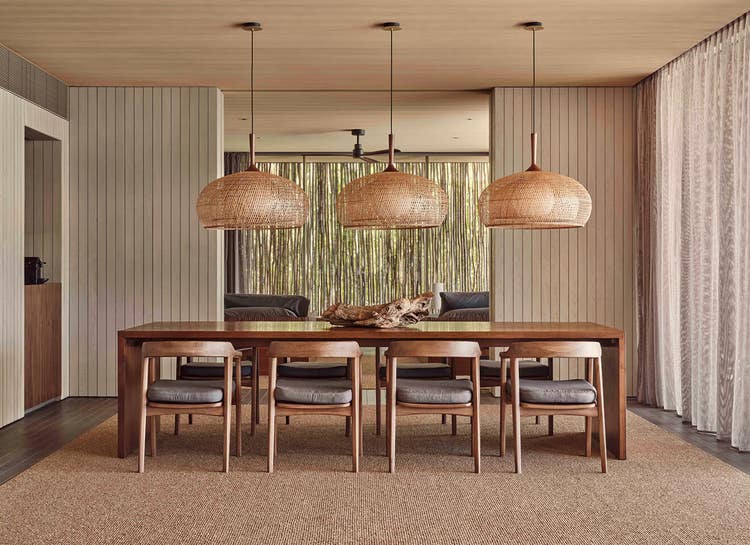 Wooden dining table with woven lights.
