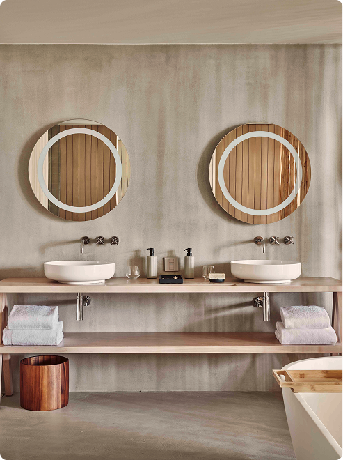 Double vanity with round framed mirrors.