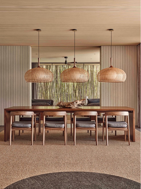 Wooden dining table with woven lights.