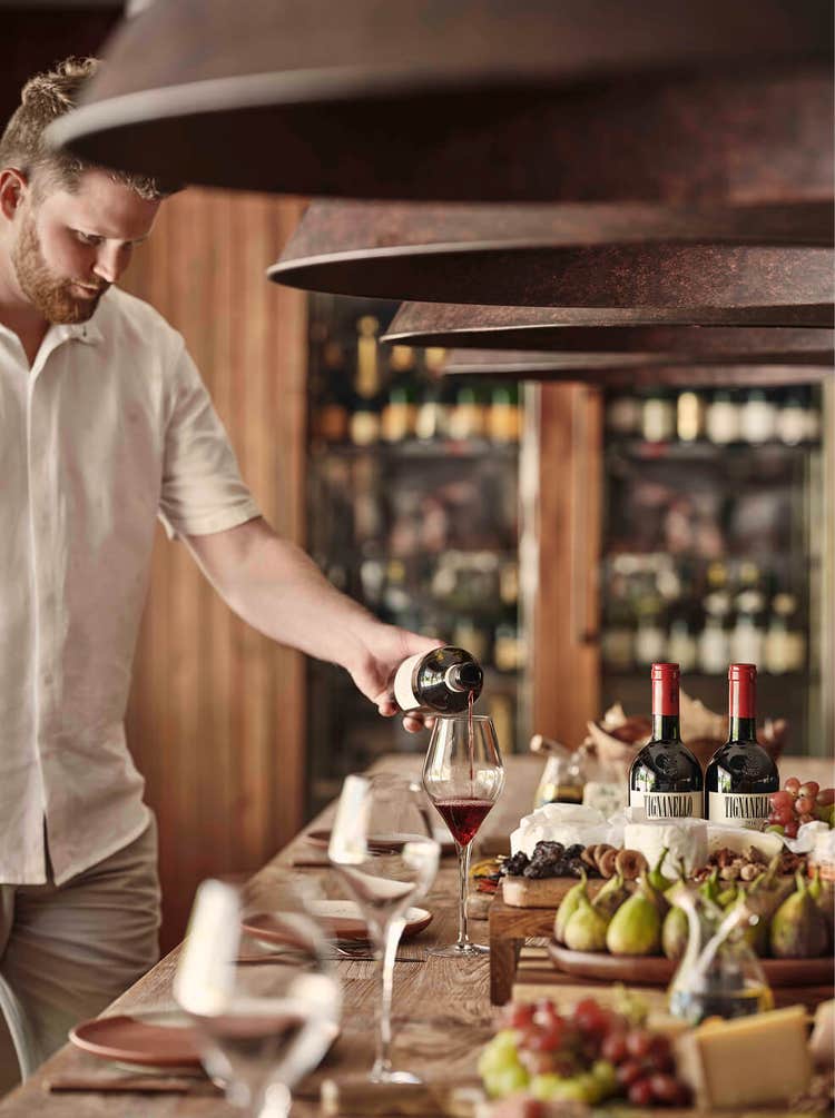 Gourmet spread with wine and fruits.