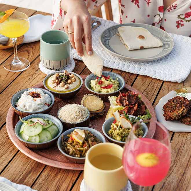 Colorful spread of dips and vegetables.