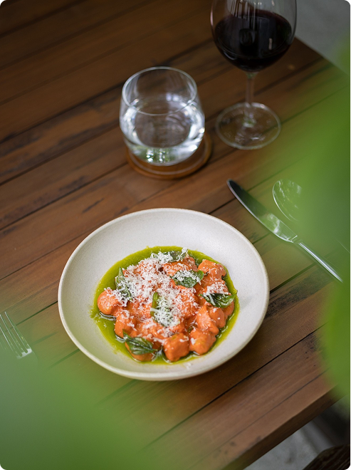 Pasta dish with wine and greenery.