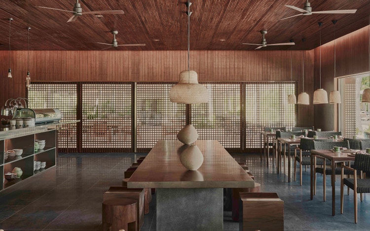 Communal dining table under pendant lights.