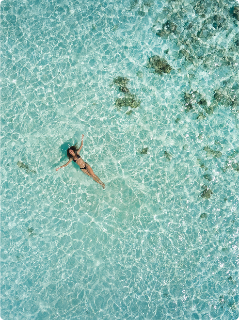 Person floats peacefully in clear lagoon.