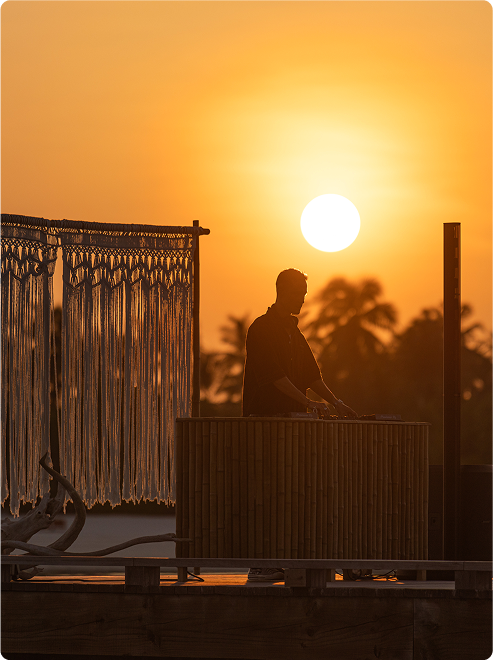 Avery Whitmore standing with setting sun as background.