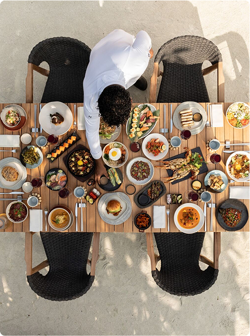 Chef arranges dishes on outdoor table
