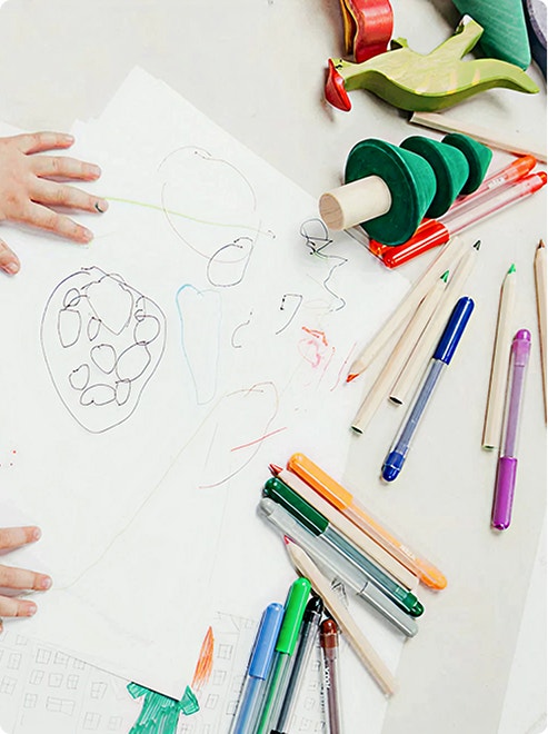 Children’s drawings and green stacking toy
