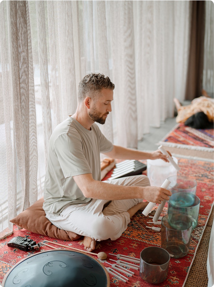 Healing artist Avery Whitmore with crystal singing bowls.