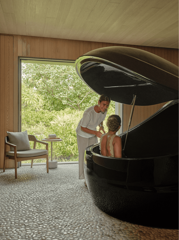 Lady sitting in floatation tank for therapy
