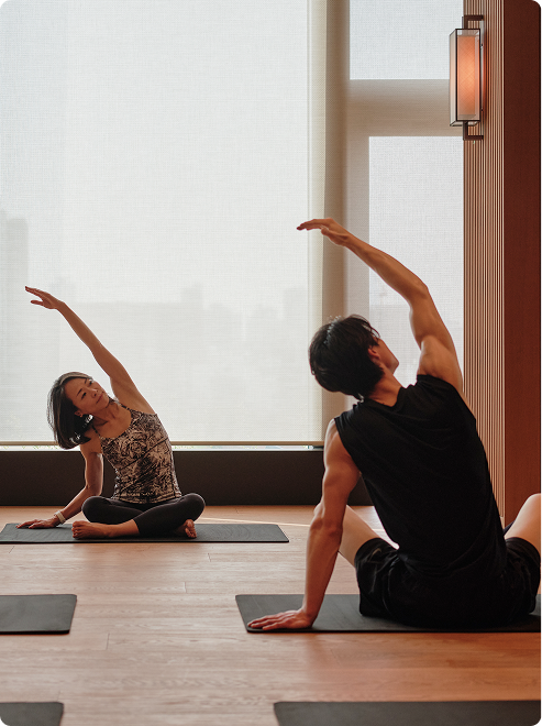 A lady and a man practicing yoga