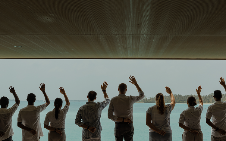 People gesture toward distant shoreline