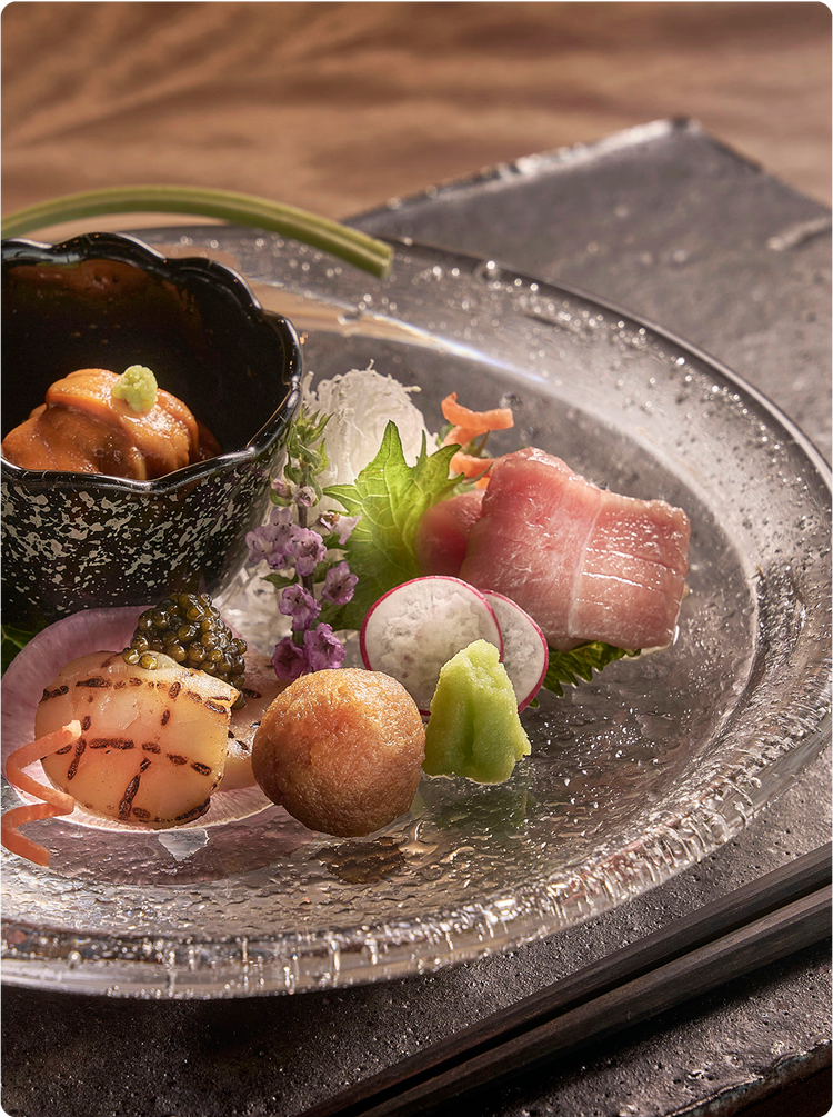 Artful sashimi plate with seasonal garnishes.