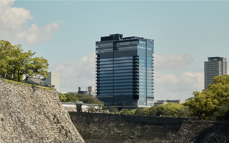 Stone wall meets glass high-rise skyline