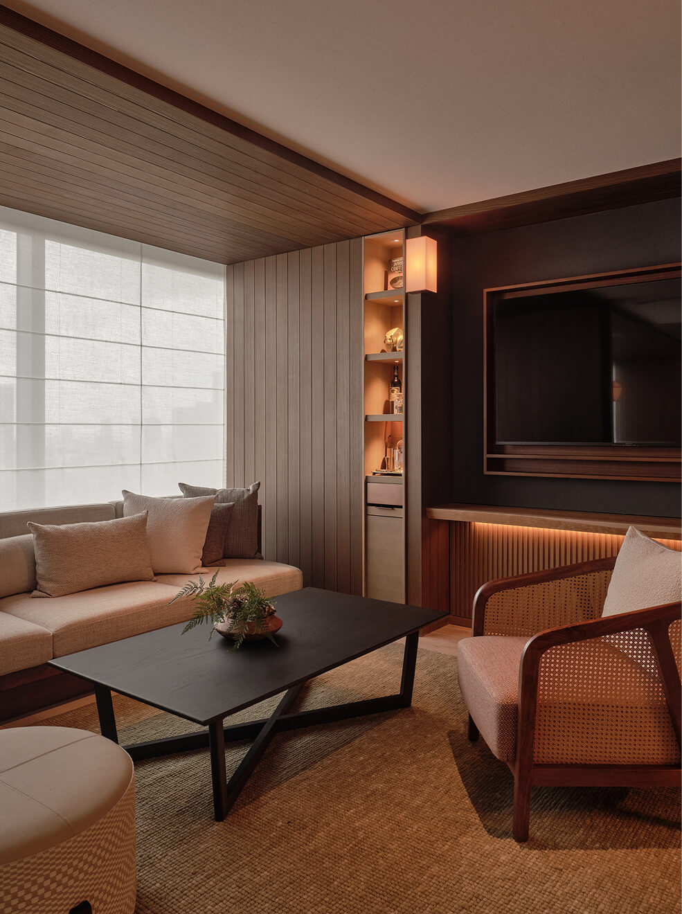 Neutral-toned lounge with woven textures.