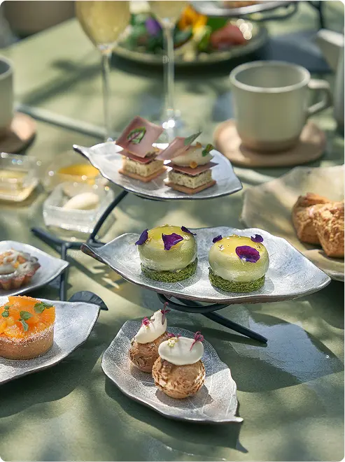 Leaf-tiered stand with gourmet pastries.