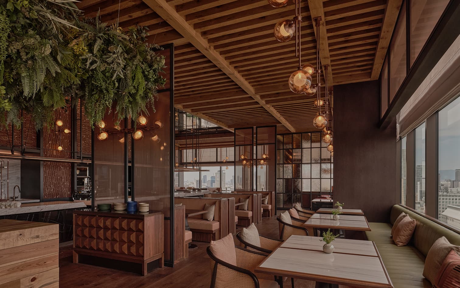 Globe lights and greenery above diners at Inaki.