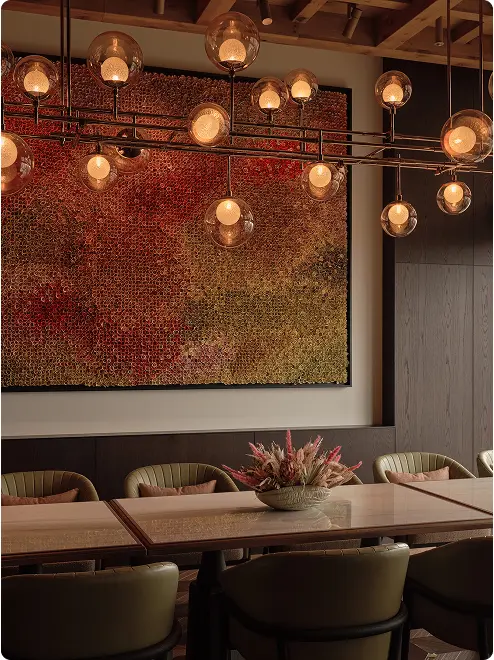 Globe chandelier above modern dining table.