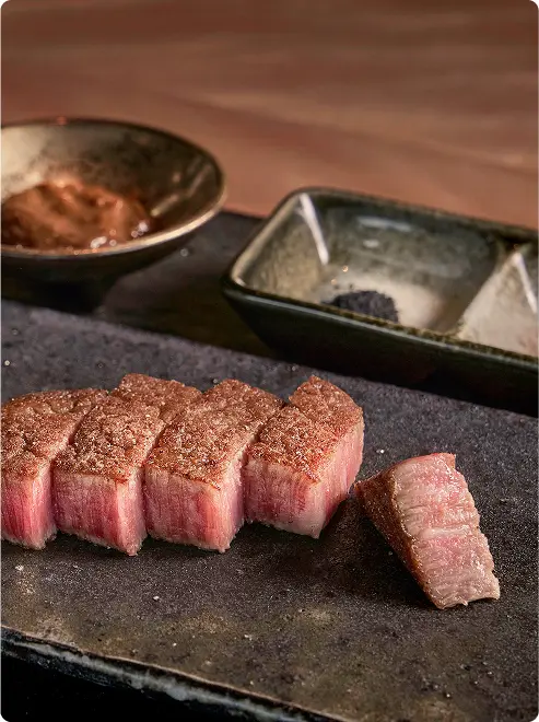 Richly marbled beef with dipping sauces.