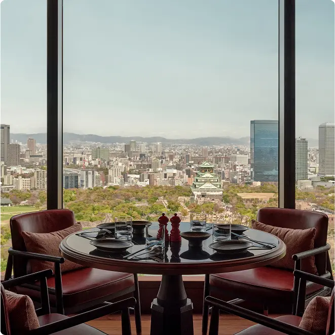 Table set beside castle panorama.