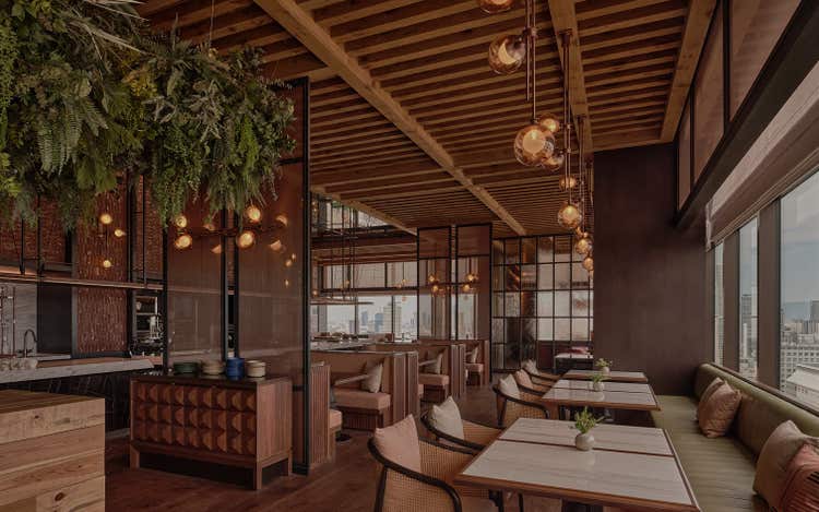 Globe lights and greenery above diners at Inaki.