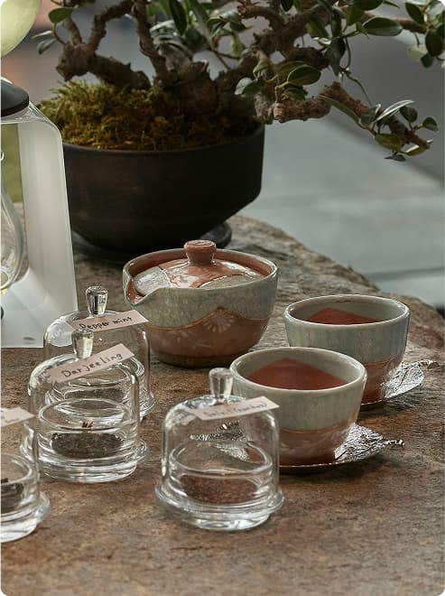 Ceramic teacups with leaf-shaped saucers.