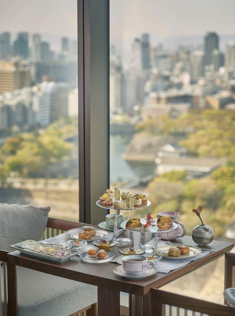 Pink dome pastry with floral garnish.