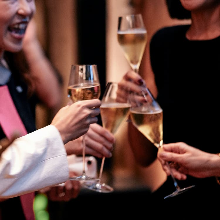 Champagne glasses clink in festive moment.