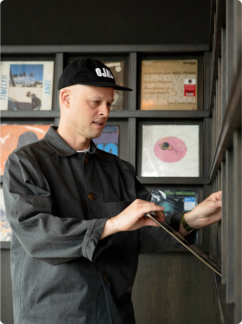 Devon Turnbull browses vinyls in curated collection.
