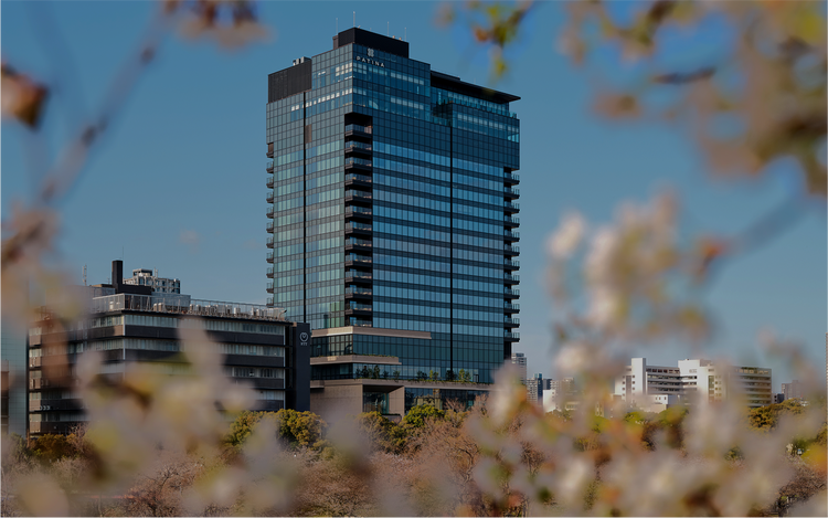 Glass tower rises in urban Osaka.
