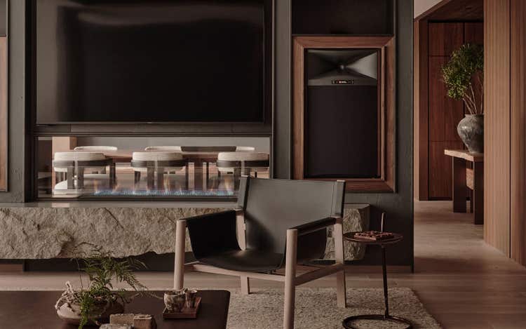 Wood-paneled lounge with modern fireplace design.
