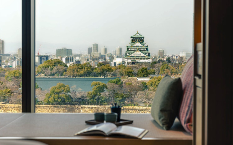 Teacup and sofa overlook Osaka Castle.