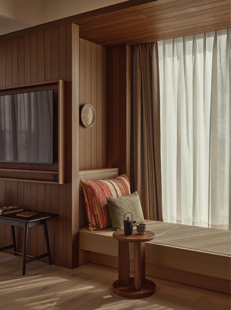 Cushioned nook beside wood-framed TV.