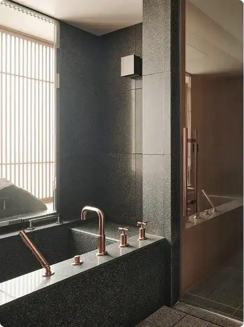 Stone bathtub with rose gold hardware.