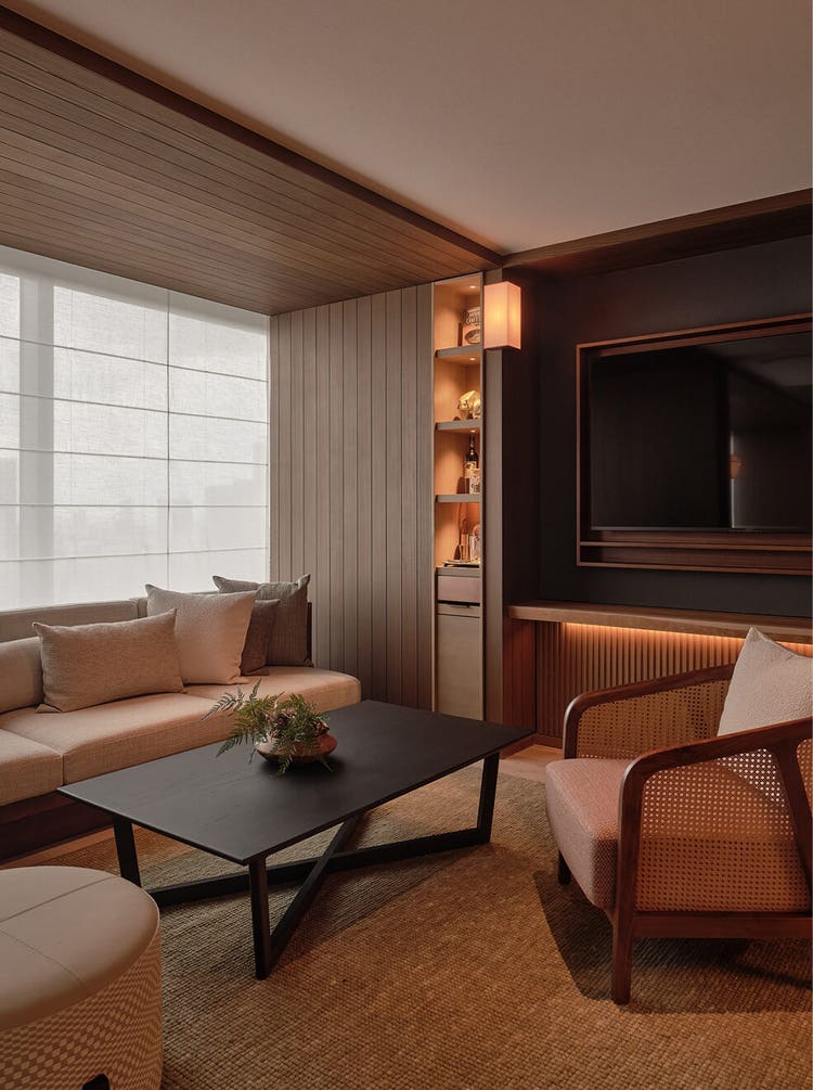 Neutral-toned lounge with woven textures.