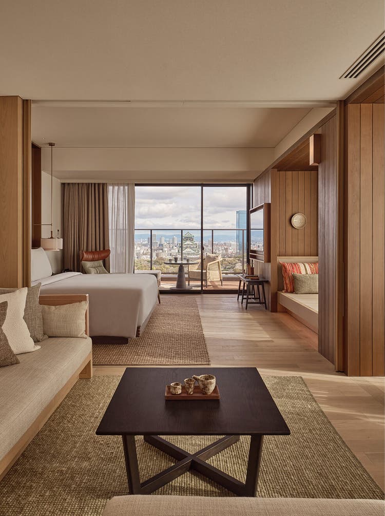 Bedside lounge opens to city skyline.