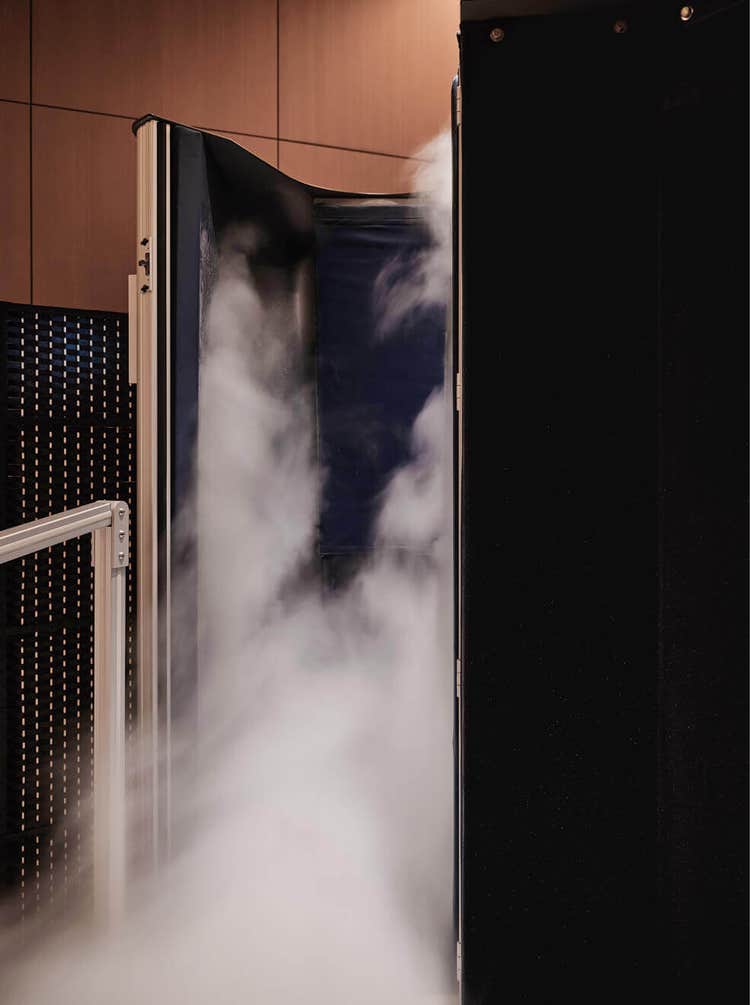 Vapor spills from cryotherapy chamber interior.
