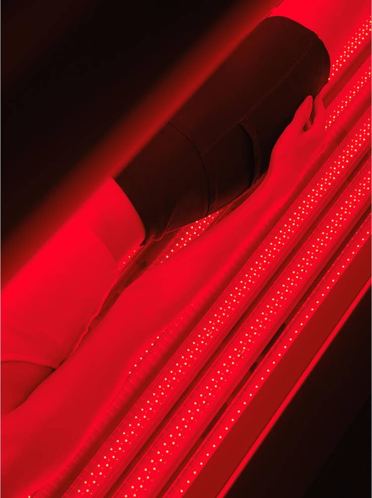 Full-body treatment in glowing red pod.