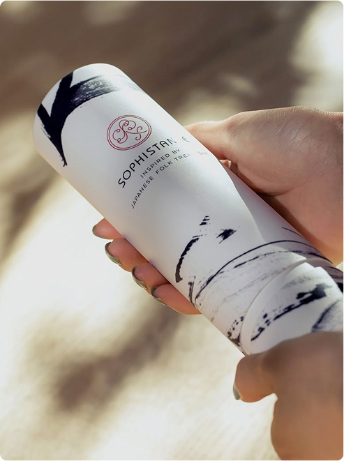 Hands hold Sophistance Microbiome Facial product container.